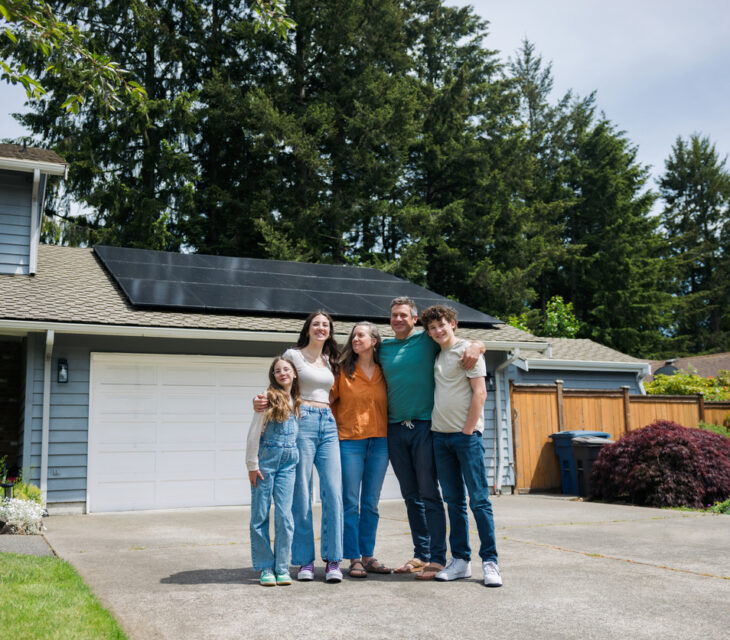 A family poses outside of their home after receiving Solar Installation Washington IL services from Solar Panther